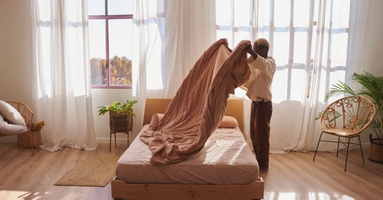 woman making bed